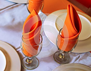 Served table with empty kitchenware and white tablecloth. Clean diningware on table photo.