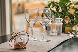 Served table set at summer terrace cafe with two glasses of wine