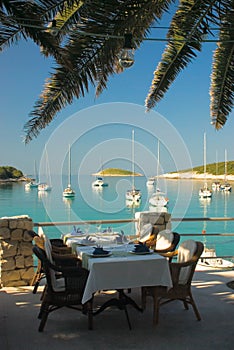 Served tables at yachting club beach restaurant