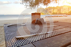 Served wooden table on a tropical beach. Prepared for breakfast near the sea