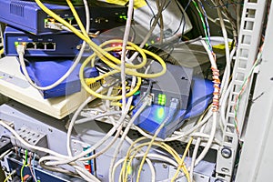 Server cabinet with network Internet equipment. Chaotic interlacing of wires between modems, switches and Internet bridges. Rack