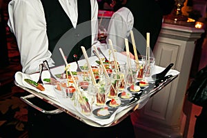 Server holding a tray of appetizers at banquet