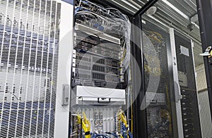 Server rack in big data center inside close up. Supercomputer with hardware, storage blades, cables and wires. Datacentre