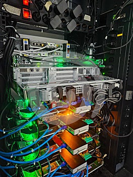 Server Rack with Complex Network Cables and Glowing Green Indicator Lights