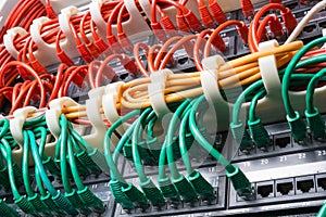 Server rack with red, yellow and green cables