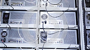 Server room for bitcoin mining farms with miners set up on wired shelves