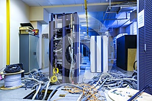 Server room with racks in datacenter and internet problem causing by disorder of wiring. photo