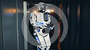 Server unit with a tall cyborg operating a computer