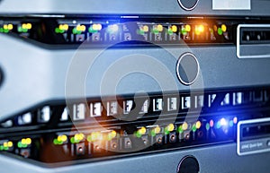 Server units in cloud service data center showing flickering light indicators for massive data connection bandwidth, close up shot