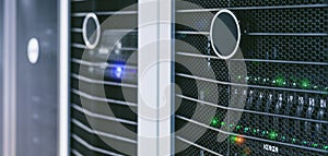 Server units in cloud service data center showing flickering light indicators for massive data connection bandwidth, close up shot