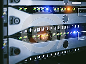 Server units in cloud service data center showing flickering light indicators for massive data connection bandwidth, close up shot