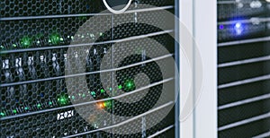 Server units in cloud service data center showing flickering light indicators for massive data connection bandwidth, close up shot