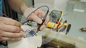 Service center. Electronics repair shops. A man repairs the fridge. Aluminum brazing.