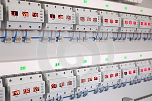 Service center for the repair of power voltage relays. Human checking electrical device with digital display. Numbers on the test