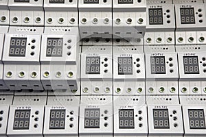 Service center for the repair of power voltage relays. Human checking electrical device with digital display. Numbers on the test