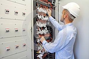 Service Engineer adjusts equipment in data center. Server room of datacenter