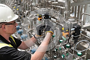 A service engineer checks an pneumatic valve