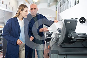 Service engineer conducts training on work on copiers of an office worker