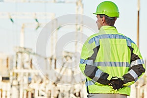 Service engineer standing in front of electro power plant