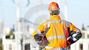 Service engineer standing in front of heat electropower station