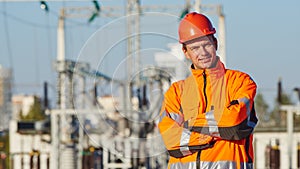 Service engineer worker. Portrait of smiling man in front of electric power distribution station