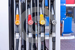Service gas station with fuel, oil, gasoline and diesel, side view. Close-up of a gas pump fueling gun. Petrol station