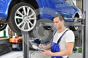 Service and inspection of a car in a workshop - mechanic inspect photo