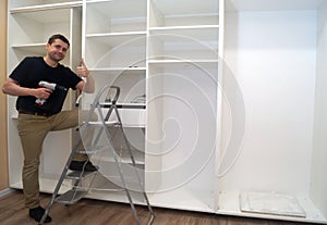 Service man at the time of assembling of built-in wardro