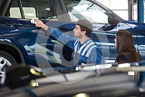 Service mechanic showing a customer to her car