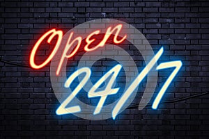 Service open any time and every day or operating nonstop concept theme with a red and blue light neon sign against a brick wall