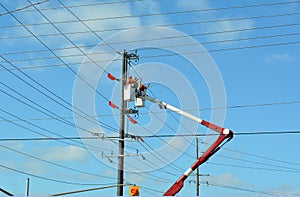 Service persons in a lift bucket working on hydroelectric lines