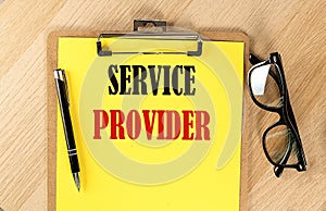 SERVICE PROVIDER text on a yellow paper on wooden background