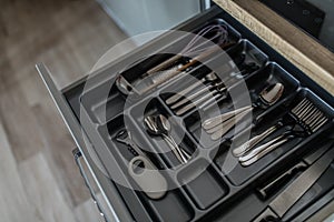 Service set of cutlery set: silver spoons, forks and knifes. Kitchen supplies close up view. Ready to eat concept