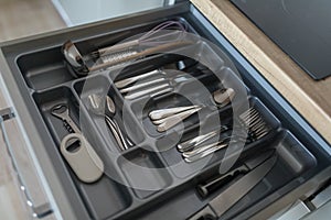 Service set of cutlery set: silver spoons, forks and knifes. Kitchen supplies close up view. Ready to eat concept