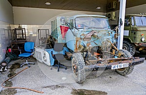 Service station with old rusty disassembled soviet truck
