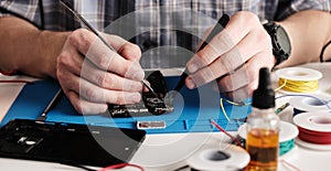 Service Technician Fixing Broken Smartphone In Service Center