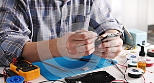Service Technician Fixing Broken Smartphone In Service Center