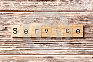 Service word written on wood block. Service text on table, concept