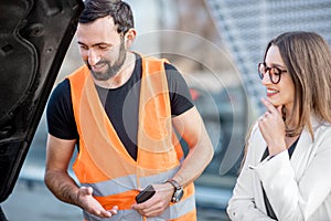 Service worker with businesswoman and car