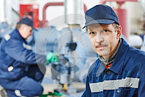 Service worker at industrial compressor station