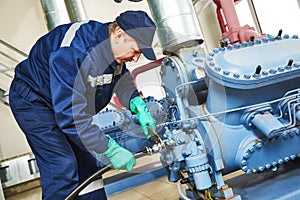 Service worker at industrial compressor station photo