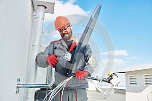 Service worker installing and fitting satellite antenna dish for cable TV