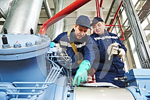 Service workers at industrial compressor station