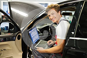 Serviceman in a car workshop