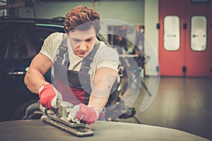 Serviceman in a car workshop