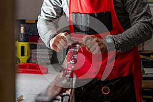 Serviceman cleans excess paraffin from the sliding surface with a special tool