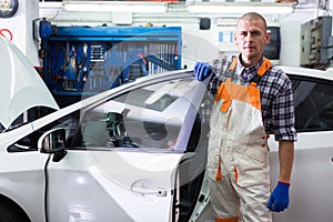 Serviceman making car diagnostics in a workshop