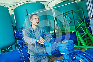 Serviceman operating industrial water purification or filtration equipment