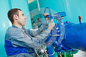 Serviceman operating industrial water purification or filtration equipment