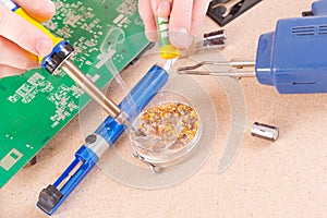 Serviceman soldering on PCB